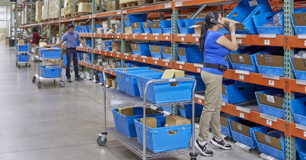 A warehouse worker using a voice-directed headset