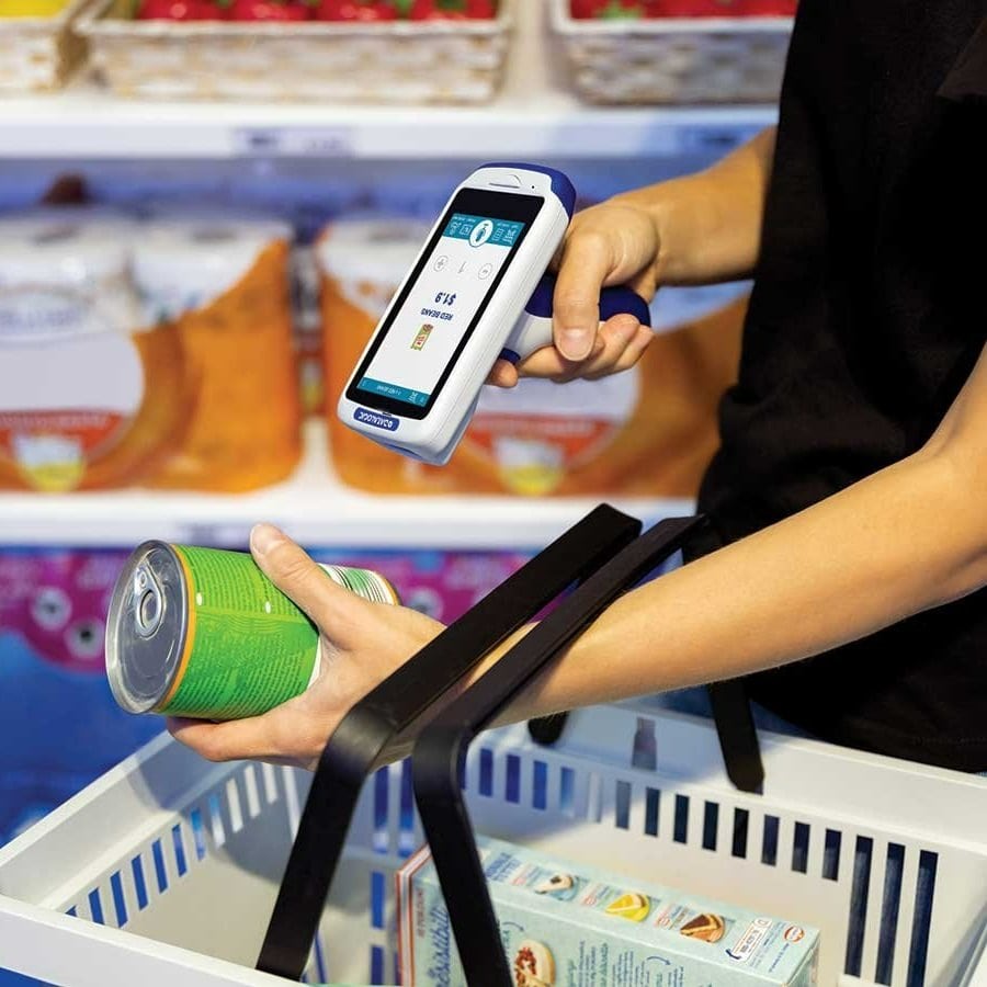 A person in a retail store using a handheld barcode scanner to scan products