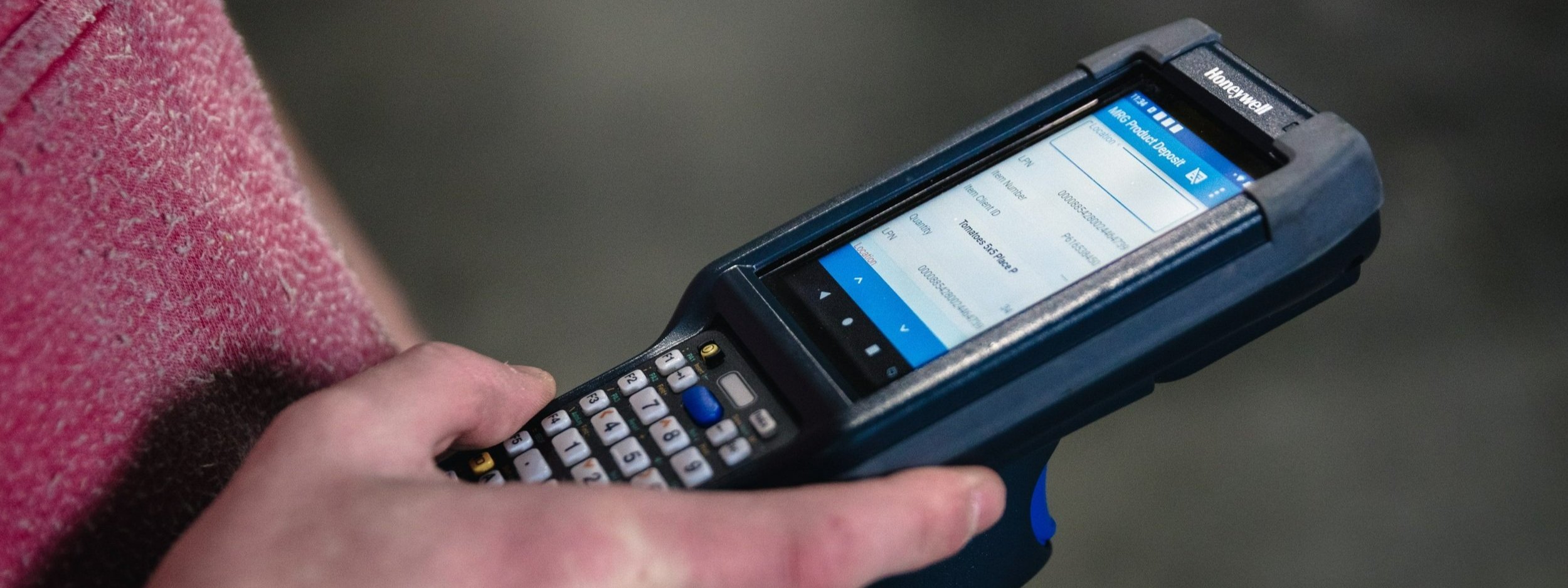 Someone using a handheld Honeywell barcode scanner