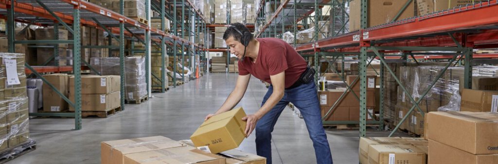 A warehouse worker using a Honeywell voice automated headset