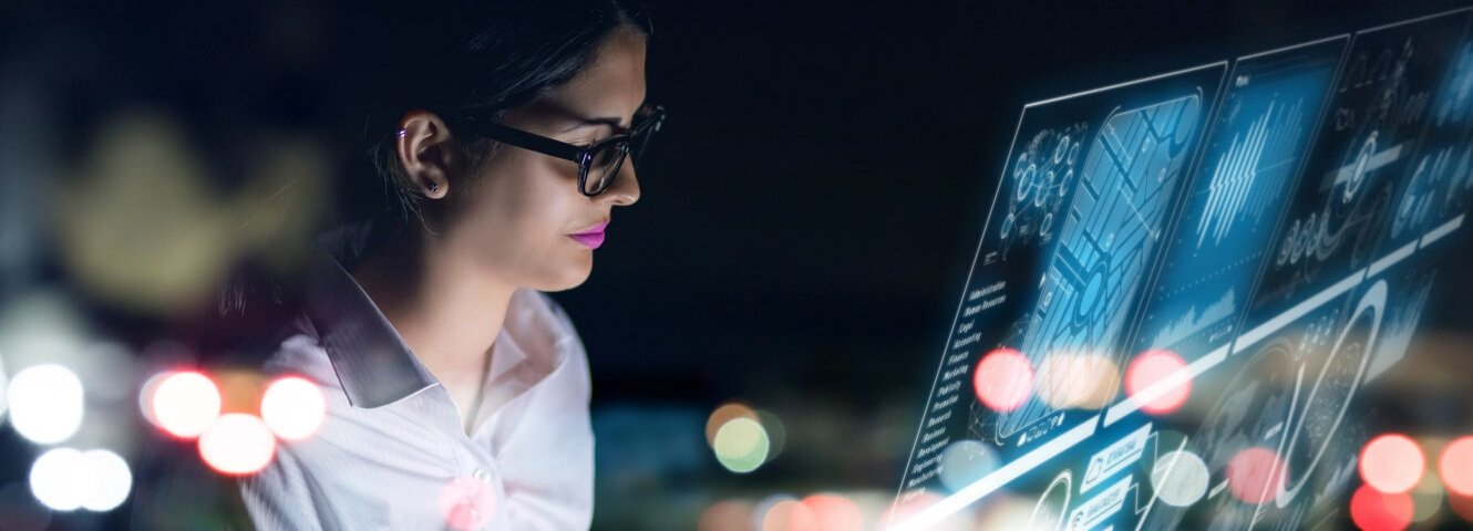 A woman looking at a holographic display