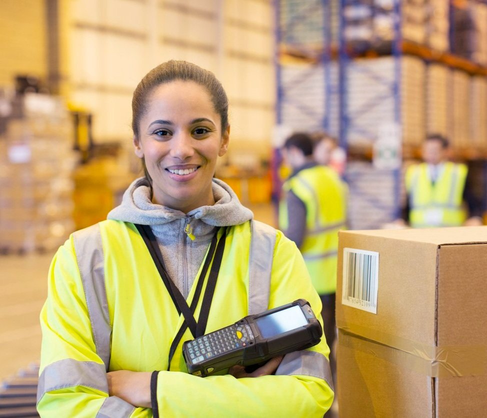 A woman in warehouse with scanner.