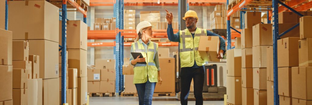 People carrying boxes in the warehouse