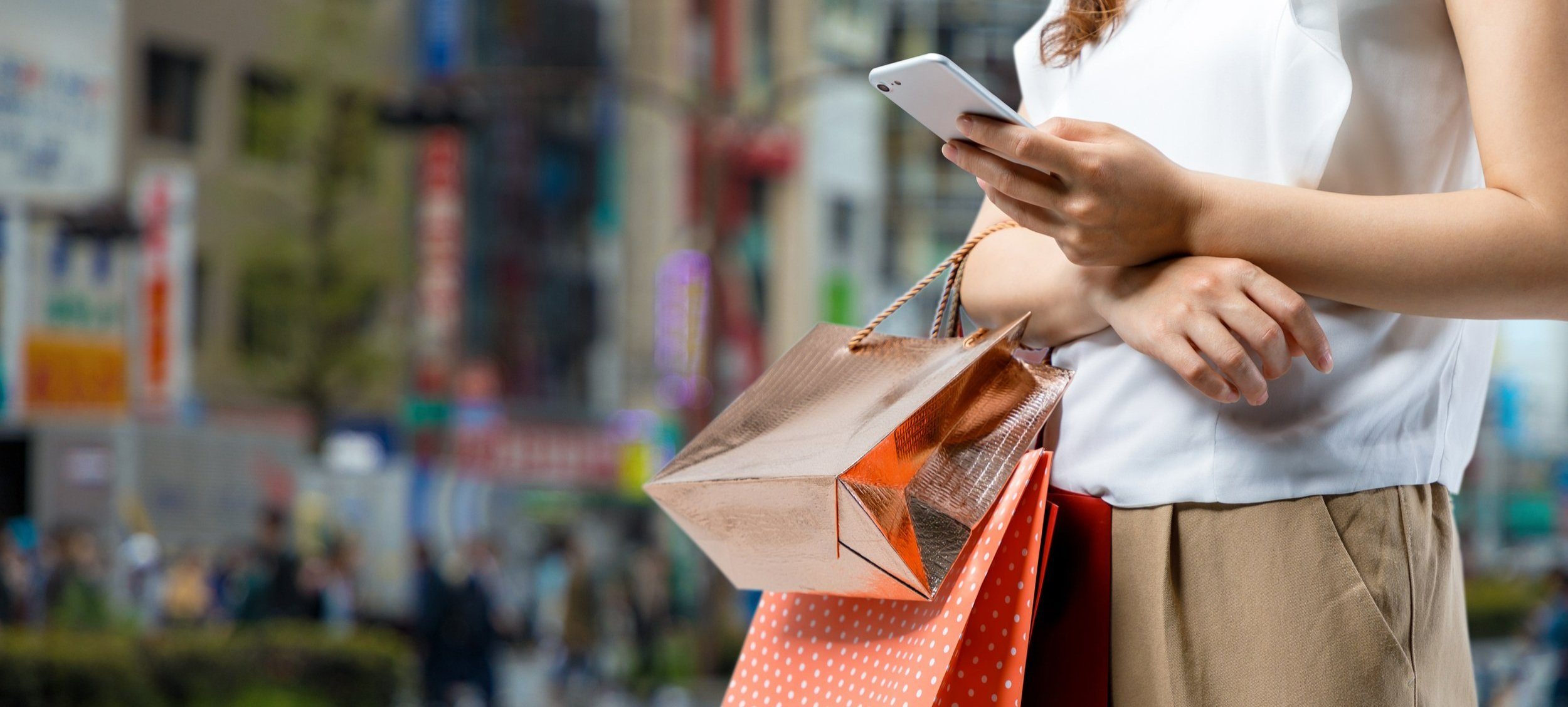 A woman looking at her phone in a retail store