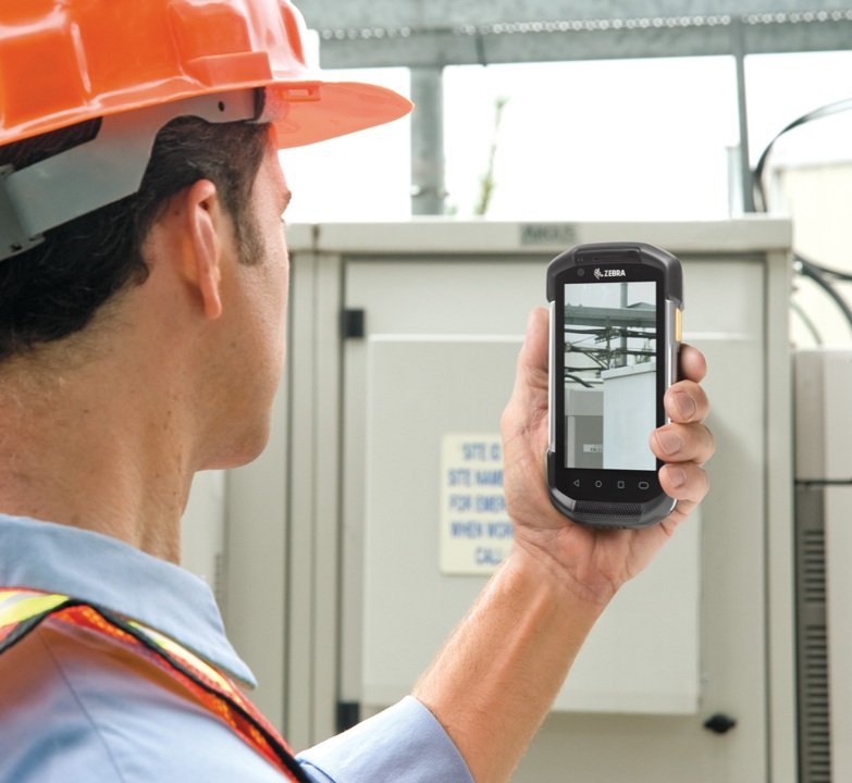 A man holding a Zebra Mobile Computer.