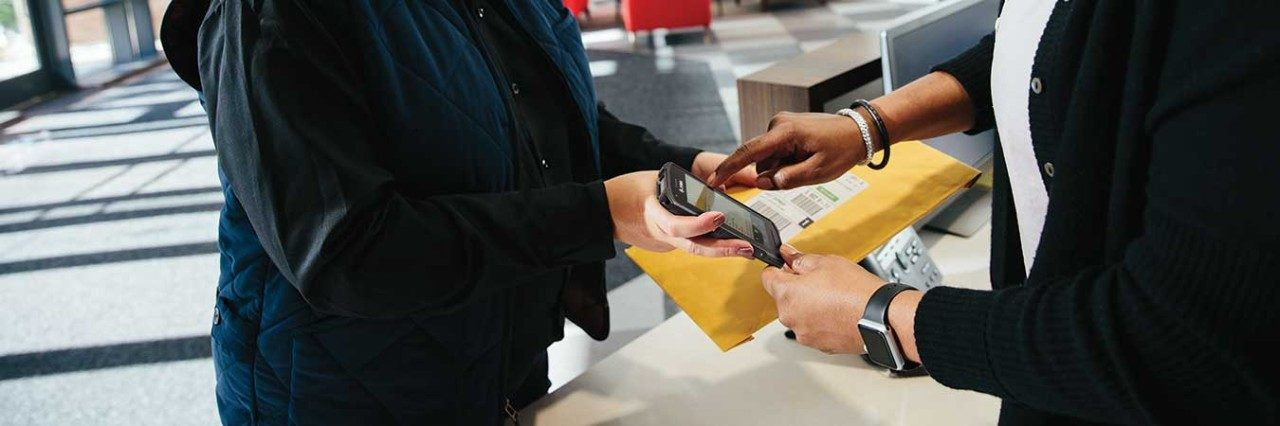 Someone using a mobile computer to verify delivery