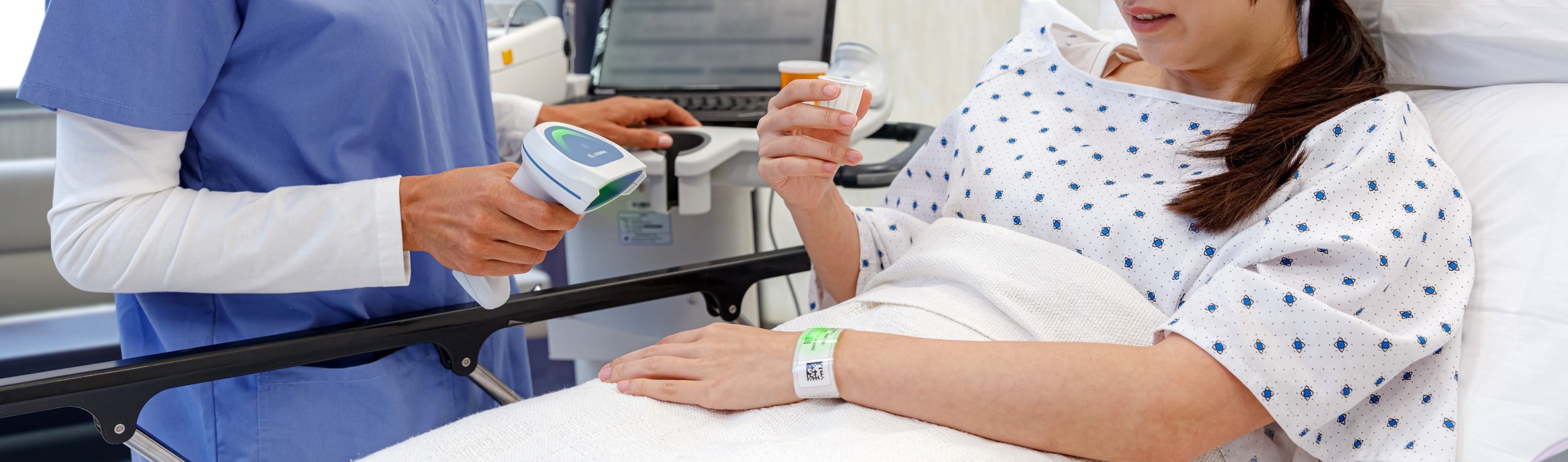 Someone using a healthcare handheld barcode scanner in a hospital