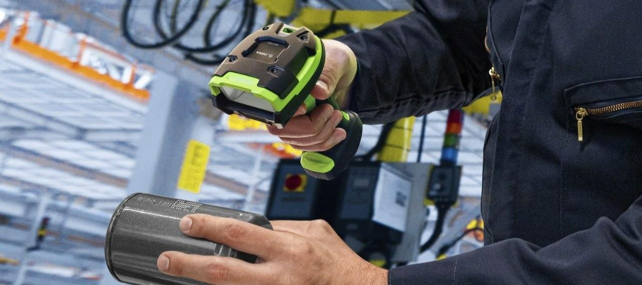 Someone using a handheld Zebra barcode scanner