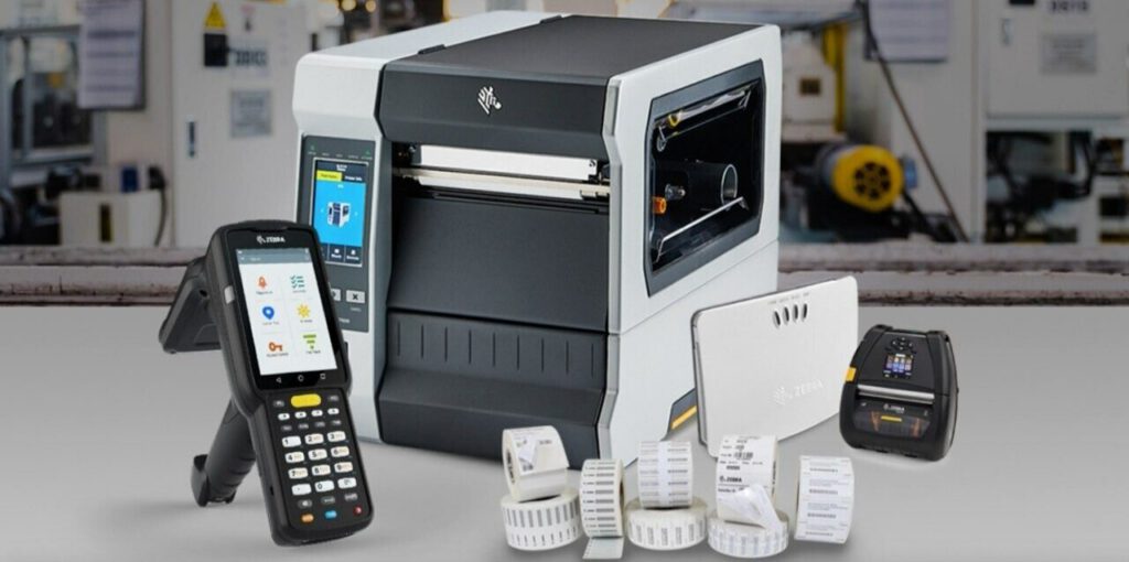 A Zebra handheld barcode scanner, printer and router.