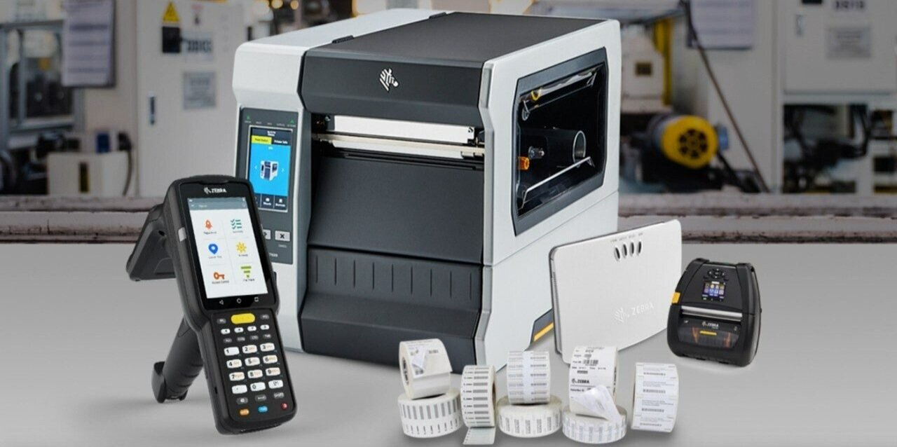 A Zebra handheld barcode scanner, printer and router.