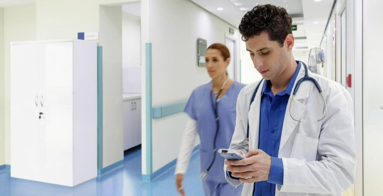 A healthcare worker using a mobile computer in a hospital