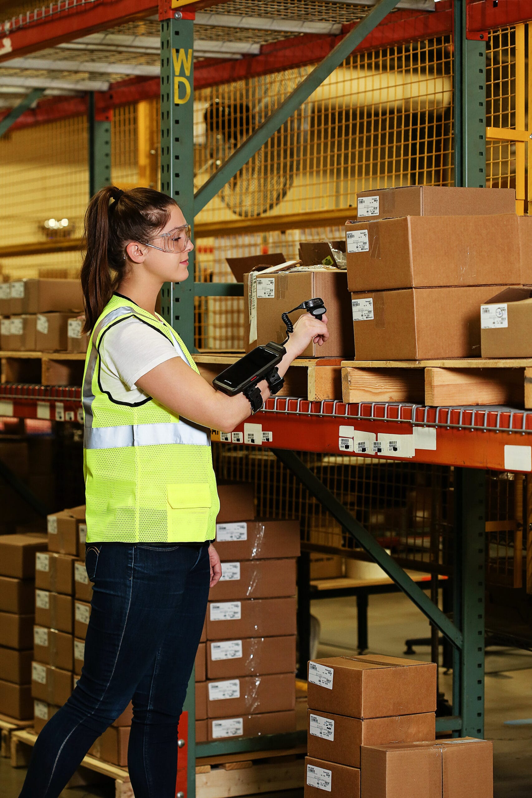 A warehouse worker using a wearable barcode scanner and mobile computer