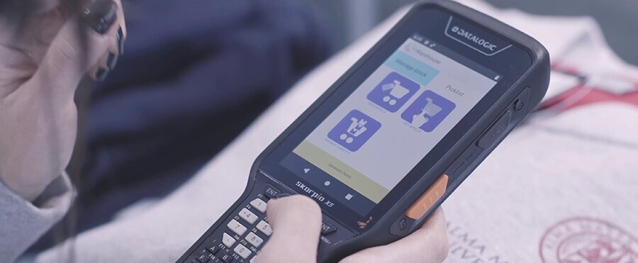 Someone using a Datalogic handheld scanner