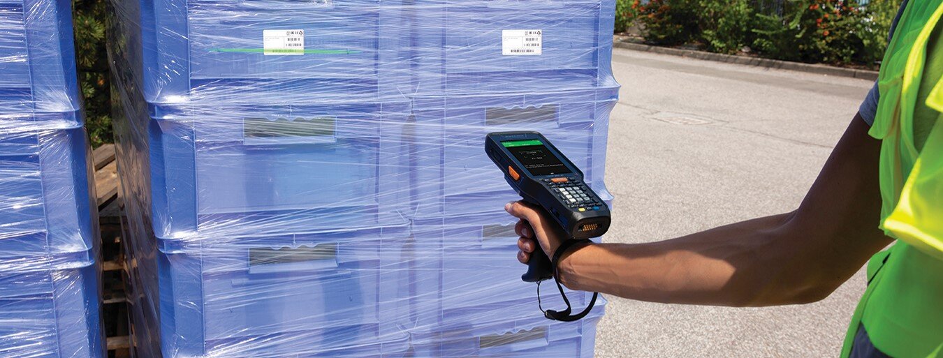 A person using a handheld barcode scanner on products