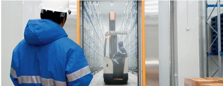 A man operating a forklift in cold storage