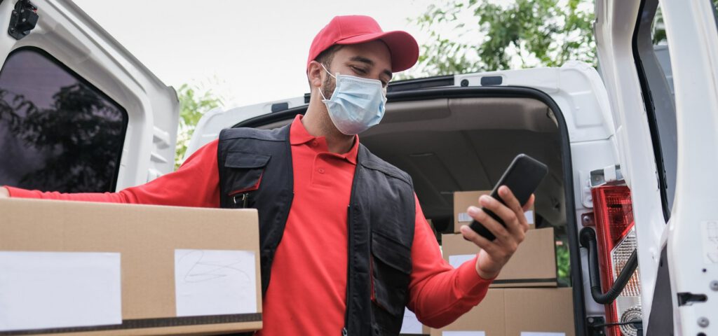 A delivery man using a smartphone