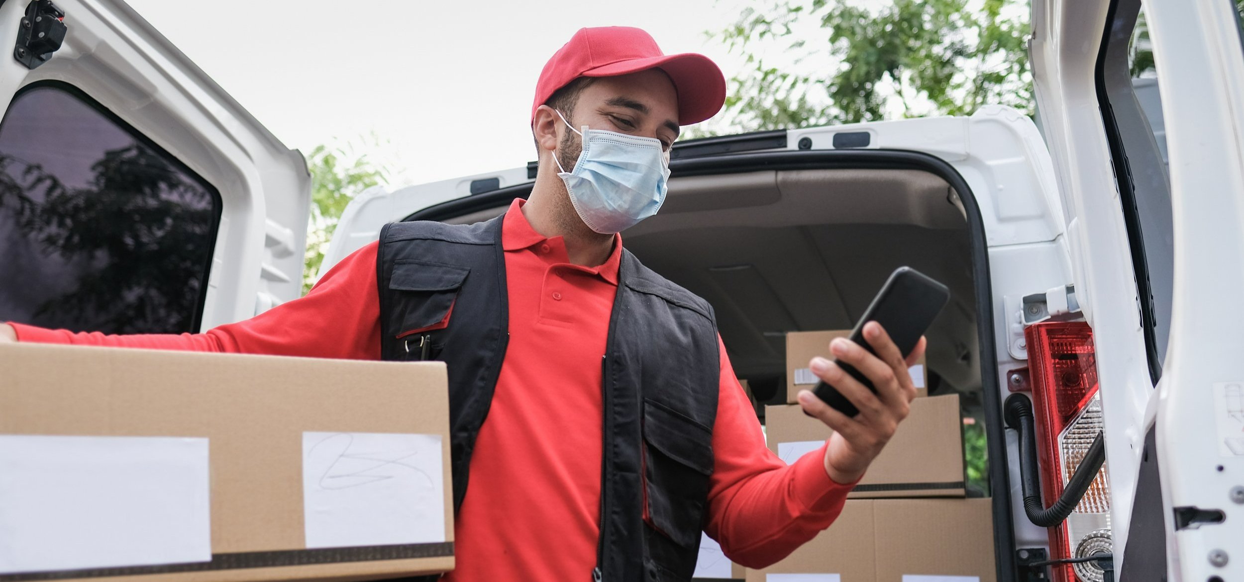 A delivery man using a smartphone
