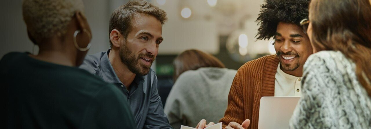 A group of people talking and smiling