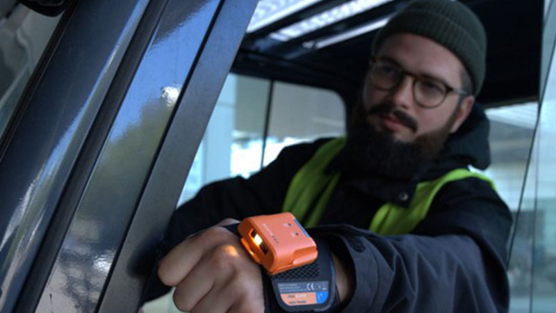 A man using a ProGlove wearable scanner