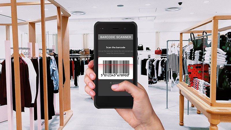 Someone holding a wireless handheld barcode scanner.