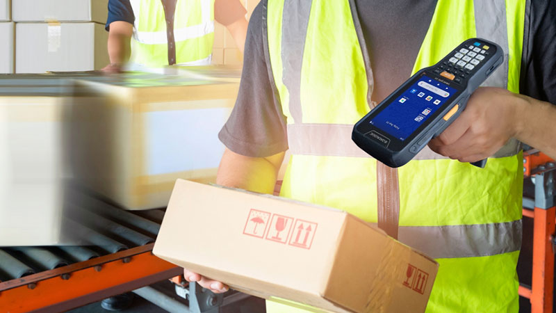 A warehouse worker using a mobile device scanner