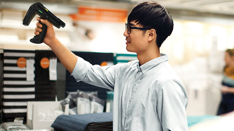 A man using a handheld barcode scanner