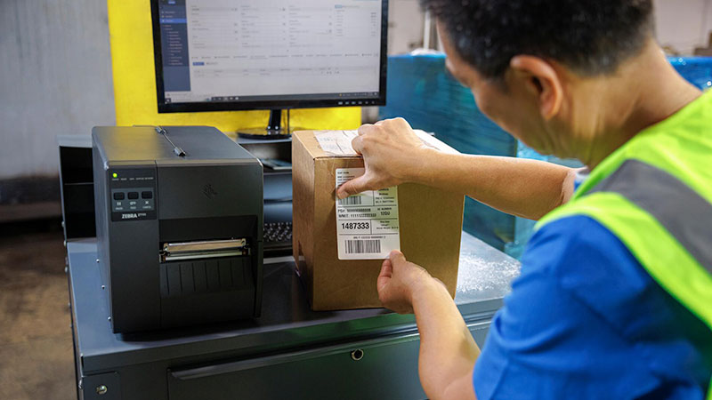 A man using an industrial printer