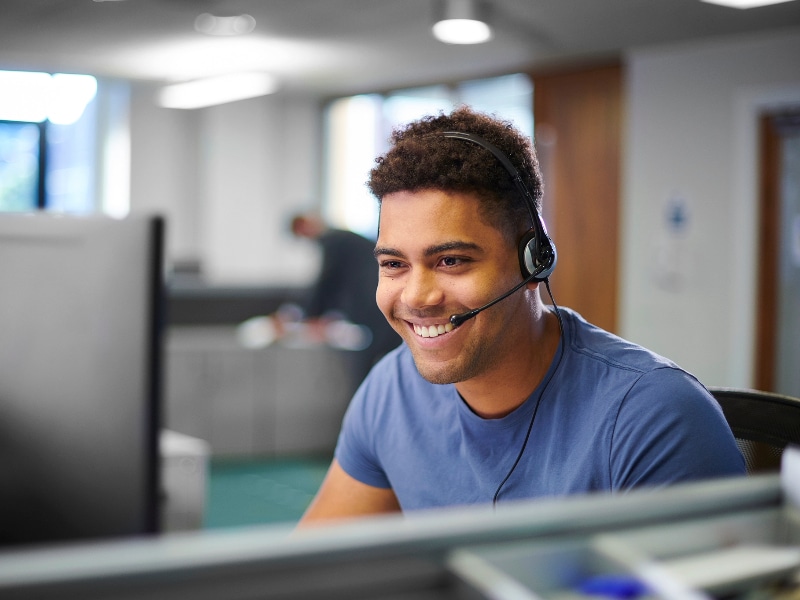 An IT support man talking through a headset