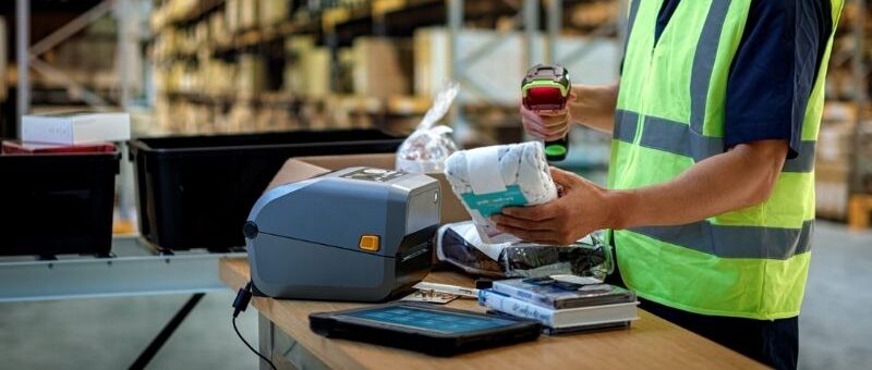 A man using a barcode scanner in the warehouse