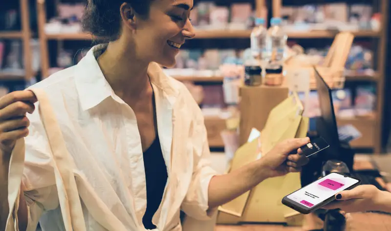 A woman paying with a Social Mobile device.