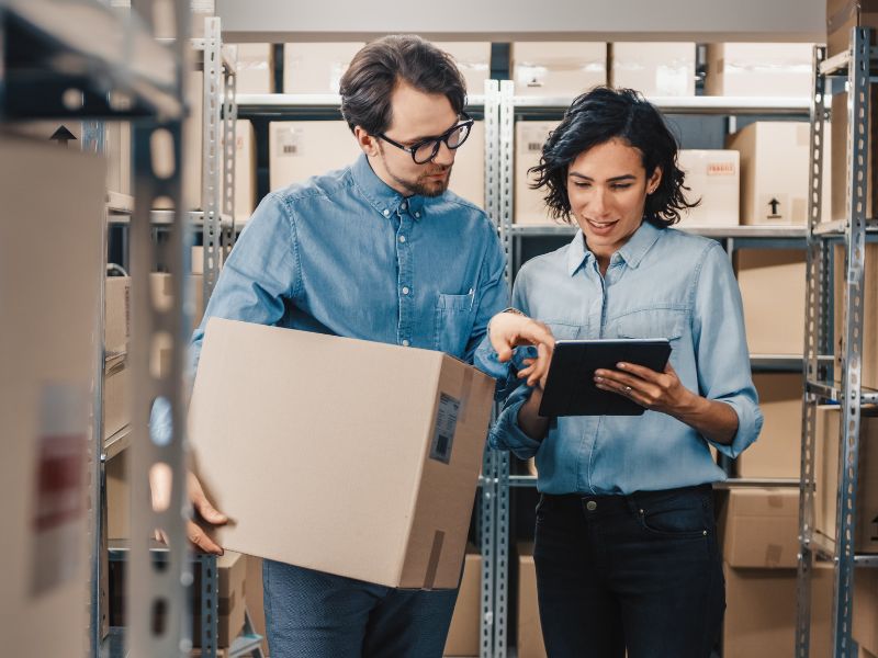 Two people looking at a tablet in a warehouse