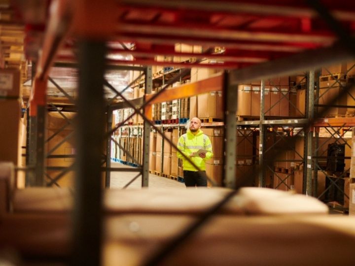 A man using an iPad in a warehouse